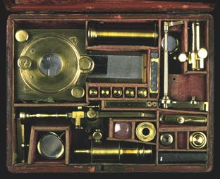 A microscope compendium, with all parts disassembled and packed away in a case.