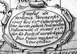 Inscription on the globe, with decorative scrollwork outlining the cartouche